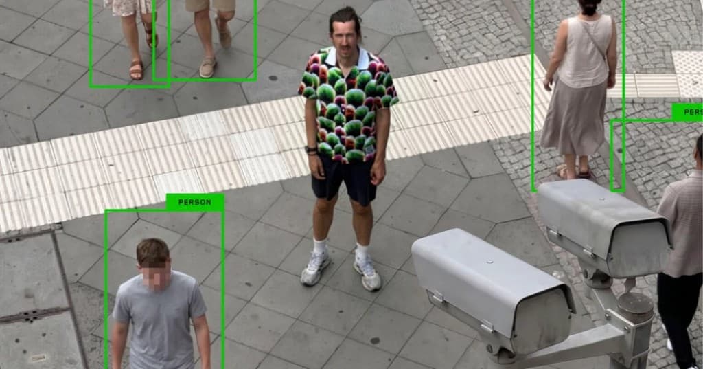 Digital camouflage targets person-class boxes on specific detectors; face detection, facial recognition, and BGBlur face blur use different signals — so the shirt does not reliably beat modern multi-stage AI surveillance or publish-side anonymization. Featured image